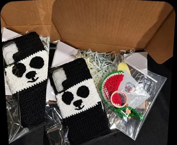 Two panda crochet phone covers packed with a small watermelon gift
